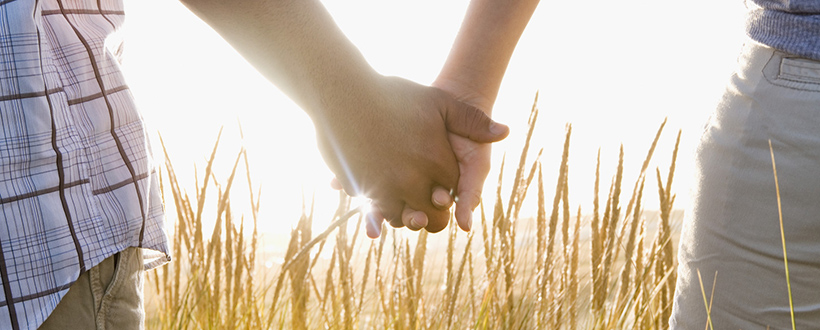 Multi-ethnic couple holding hands